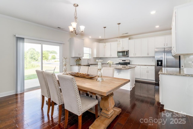 4357 Hornyak Dr, Monroe, NC 28110 - dining space featuring dark wood-type flooring, ornamental molding, a chandelier, and recessed lighting
