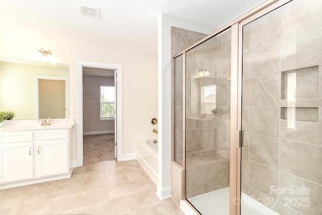 4357 Hornyak Dr, Monroe, NC 28110 - bathroom featuring vanity, a shower stall, a bath, and tile patterned flooring