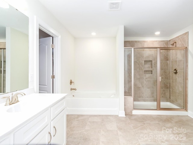 4357 Hornyak Dr, Monroe, NC 28110 - bathroom featuring vanity, a bath, a stall shower, tile patterned flooring, and recessed lighting