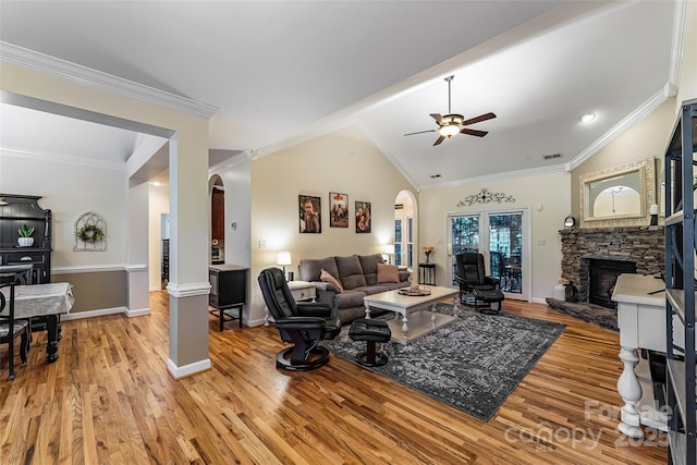 1622 Brookstone Dr, Hickory, NC 28602 - living area featuring arched walkways, a stone fireplace, ceiling fan, light wood-style flooring, and crown molding