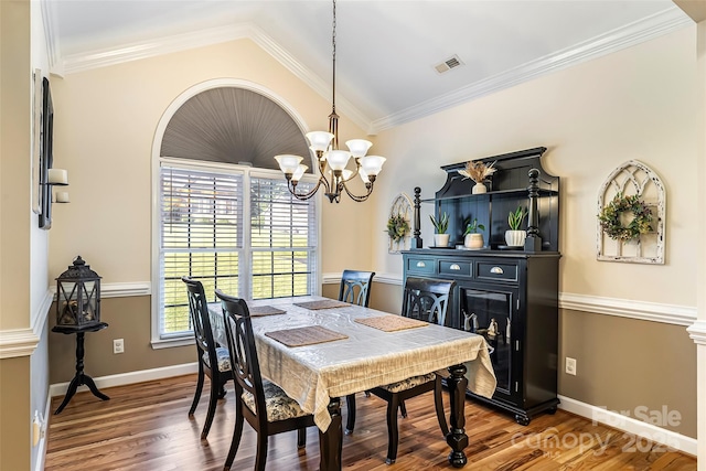 1622 Brookstone Dr, Hickory, NC 28602 - dining room with plenty of natural light, a chandelier, wood finished floors, vaulted ceiling, and crown molding