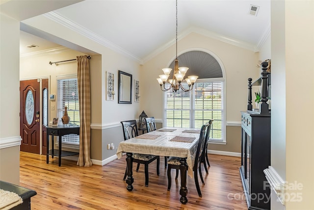 1622 Brookstone Dr, Hickory, NC 28602 - dining area with a chandelier, light wood-style flooring, ornamental molding, and lofted ceiling