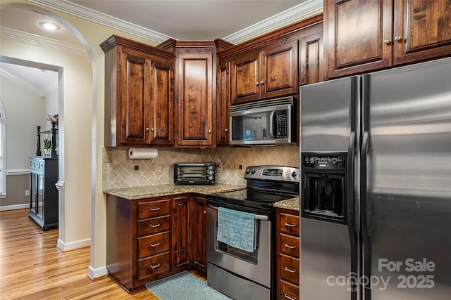1622 Brookstone Dr, Hickory, NC 28602 - kitchen with appliances with stainless steel finishes, ornamental molding, light wood-type flooring, backsplash, and light stone counters
