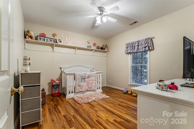 1622 Brookstone Dr, Hickory, NC 28602 - bedroom featuring a nursery area, wood finished floors, and a ceiling fan