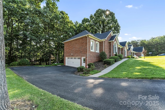 1622 Brookstone Dr, Hickory, NC 28602 - view of side of property featuring brick siding, driveway, a garage, and a yard