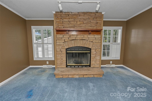 56 Founders Way, Arden, NC 28704 - unfurnished living room with carpet flooring, a stone fireplace, ornamental molding, healthy amount of natural light, and a textured ceiling