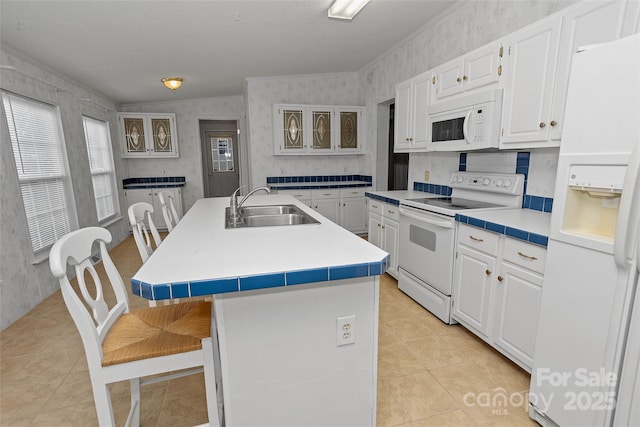 56 Founders Way, Arden, NC 28704 - kitchen featuring white appliances, wallpapered walls, light tile patterned flooring, a kitchen breakfast bar, and an island with sink