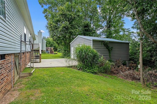 56 Founders Way, Arden, NC 28704 - view of grassy yard featuring an outdoor structure and a patio