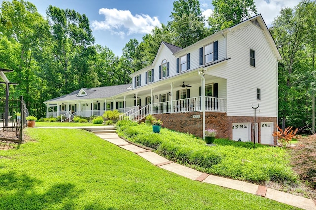 675 Ormand Rd, York, SC 29745 - view of front of home with covered porch, a garage, a ceiling fan, a front yard, and view of wooded area