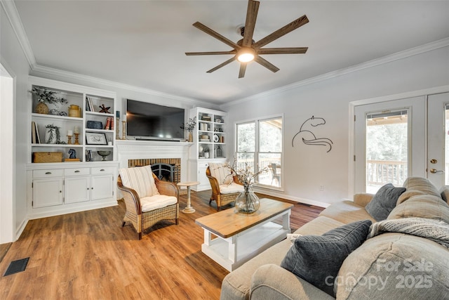 675 Ormand Rd, York, SC 29745 - living area featuring ceiling fan, crown molding, wood finished floors, a brick fireplace, and built in shelves