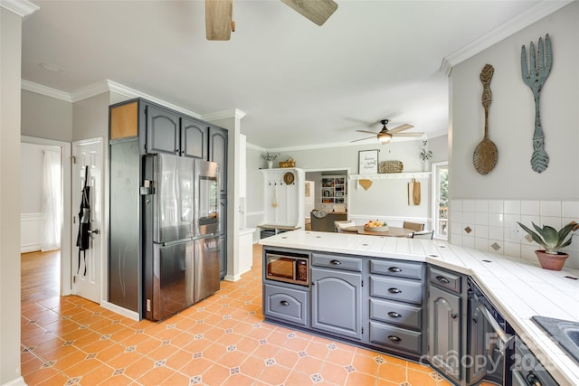 675 Ormand Rd, York, SC 29745 - kitchen with appliances with stainless steel finishes, a ceiling fan, a peninsula, ornamental molding, and gray cabinets