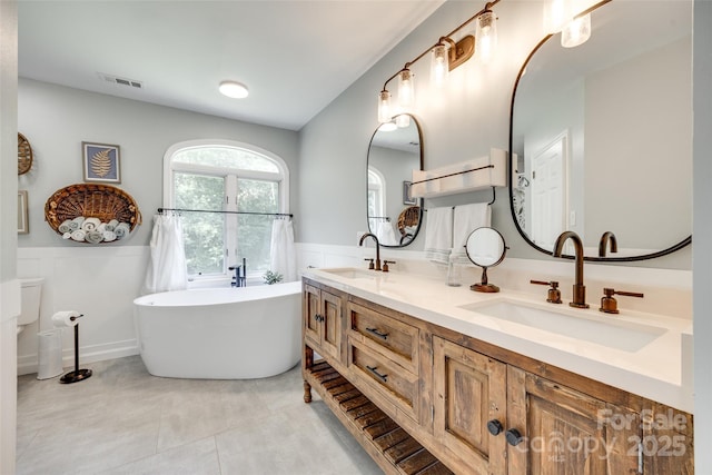675 Ormand Rd, York, SC 29745 - full bath with wainscoting, double vanity, a soaking tub, and tile patterned floors