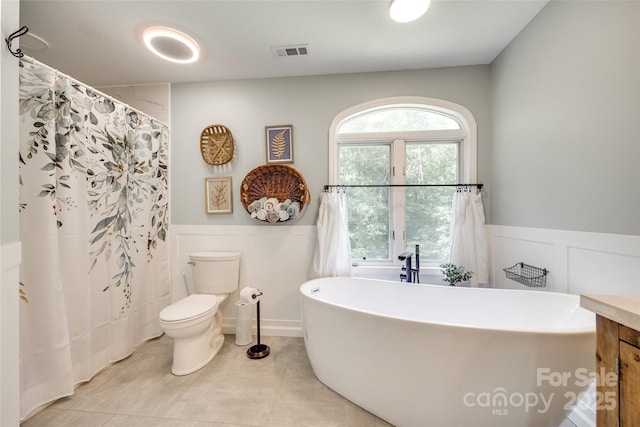 675 Ormand Rd, York, SC 29745 - full bath featuring wainscoting, a decorative wall, a freestanding tub, tile patterned flooring, and vanity