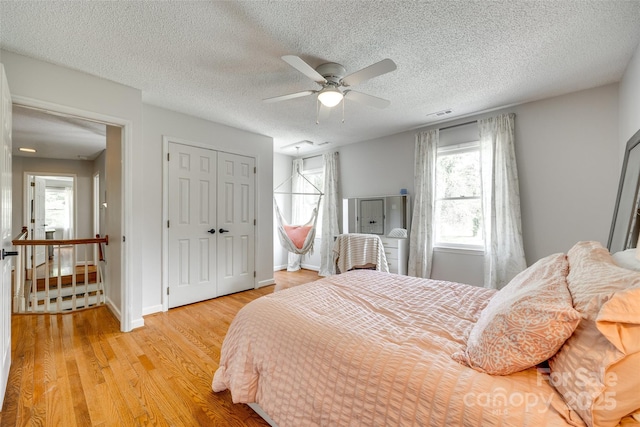 675 Ormand Rd, York, SC 29745 - bedroom with light wood-type flooring, a textured ceiling, a ceiling fan, and a closet