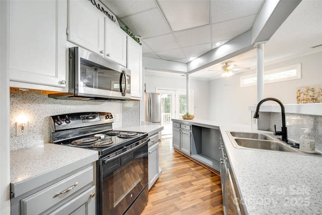 675 Ormand Rd, York, SC 29745 - kitchen featuring stainless steel appliances, light wood-style floors, light countertops, backsplash, and plenty of natural light