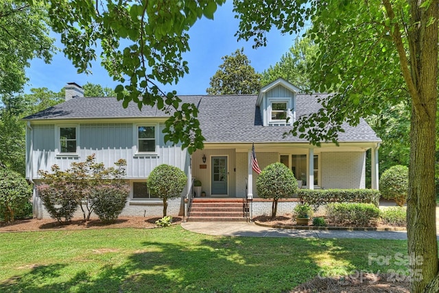 3165 Pendleton Ave, Charlotte, NC 28210 - view of front facade featuring brick siding, a front yard, roof with shingles, covered porch, and a chimney