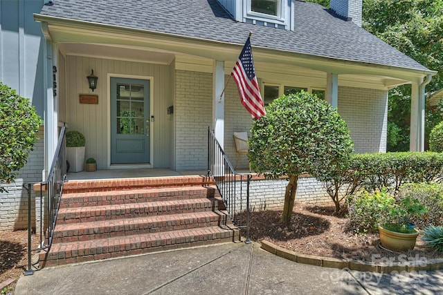 3165 Pendleton Ave, Charlotte, NC 28210 - entrance to property featuring brick siding, a shingled roof, a chimney, and a porch
