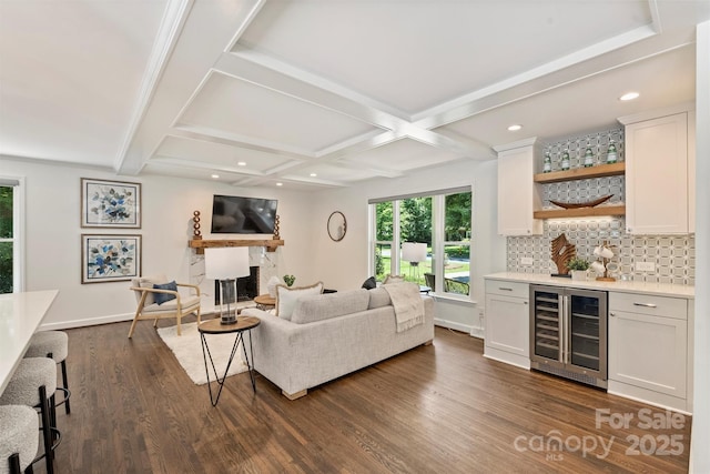 3165 Pendleton Ave, Charlotte, NC 28210 - living room with wine cooler, wet bar, dark wood-style flooring, a fireplace, and beamed ceiling