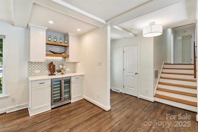 3165 Pendleton Ave, Charlotte, NC 28210 - indoor dry bar with beverage cooler, dark wood-style flooring, decorative backsplash, stairs, and beam ceiling
