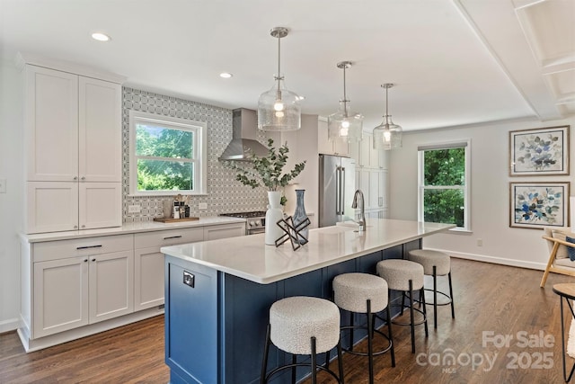 3165 Pendleton Ave, Charlotte, NC 28210 - kitchen featuring wall chimney range hood, appliances with stainless steel finishes, dark wood-style floors, backsplash, and recessed lighting
