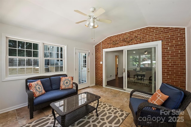 3165 Pendleton Ave, Charlotte, NC 28210 - living area featuring vaulted ceiling, brick wall, and ceiling fan