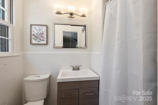 3165 Pendleton Ave, Charlotte, NC 28210 - bathroom featuring vanity, tile walls, a wainscoted wall, and a shower with shower curtain