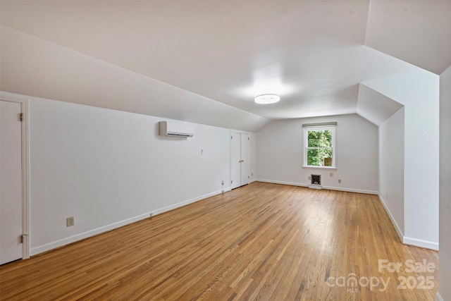 3165 Pendleton Ave, Charlotte, NC 28210 - bonus room featuring a wall mounted air conditioner, light wood-style flooring, and lofted ceiling
