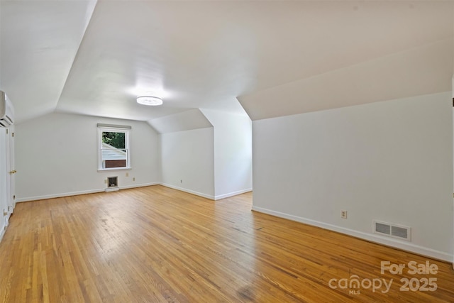 3165 Pendleton Ave, Charlotte, NC 28210 - additional living space with vaulted ceiling, light wood-type flooring, and a wall mounted air conditioner