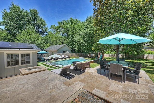 3165 Pendleton Ave, Charlotte, NC 28210 - fenced backyard featuring outdoor dining area, a playground, and a patio