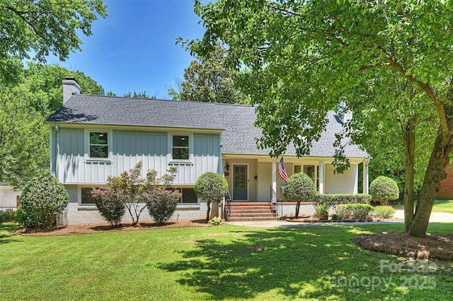 3165 Pendleton Ave, Charlotte, NC 28210 - tri-level home with brick siding, a front lawn, board and batten siding, and a shingled roof