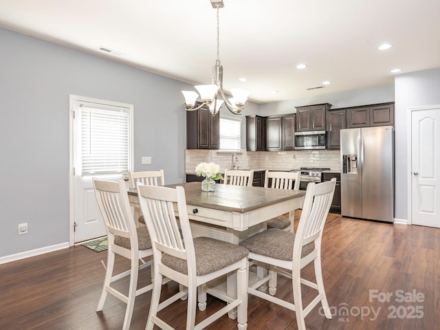 9123 Magnolia Lily Ave, Charlotte, NC 28227 - dining space featuring a chandelier, dark wood-style flooring, and recessed lighting