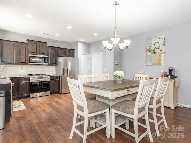 9123 Magnolia Lily Ave, Charlotte, NC 28227 - dining area featuring a chandelier, dark wood-style floors, and recessed lighting