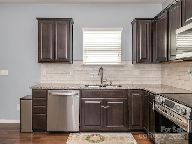 9123 Magnolia Lily Ave, Charlotte, NC 28227 - kitchen with stainless steel appliances, dark brown cabinets, light stone counters, and decorative backsplash
