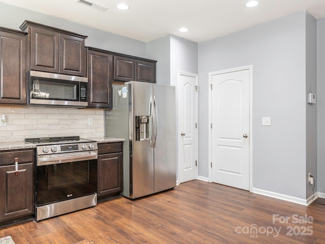 9123 Magnolia Lily Ave, Charlotte, NC 28227 - kitchen featuring stainless steel appliances, dark brown cabinets, dark wood-style floors, and recessed lighting