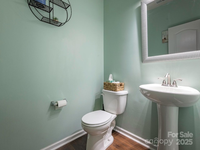 9123 Magnolia Lily Ave, Charlotte, NC 28227 - half bathroom featuring toilet and wood finished floors