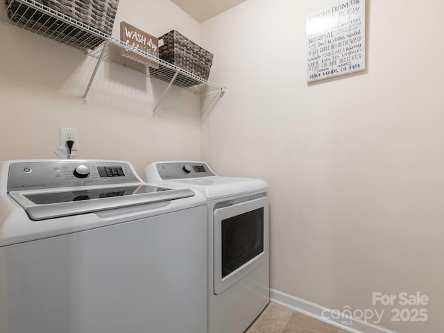 9123 Magnolia Lily Ave, Charlotte, NC 28227 - washroom with washer and dryer and light tile patterned floors