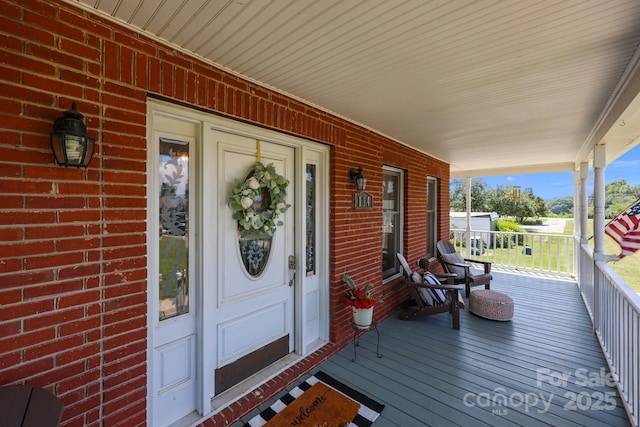 114 Windchime Ln, Mooresville, NC 28115 - property entrance with a porch and brick siding