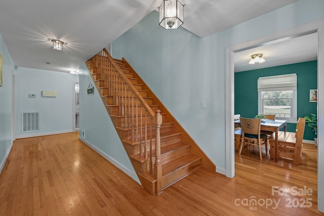 114 Windchime Ln, Mooresville, NC 28115 - stairs featuring wood finished floors and baseboards