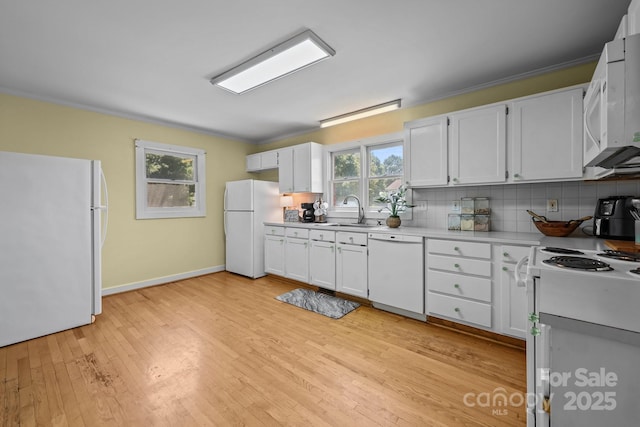 114 Windchime Ln, Mooresville, NC 28115 - kitchen featuring white appliances, light countertops, decorative backsplash, light wood-style flooring, and white cabinets