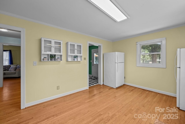 114 Windchime Ln, Mooresville, NC 28115 - unfurnished bedroom featuring freestanding refrigerator, crown molding, and light wood-style flooring