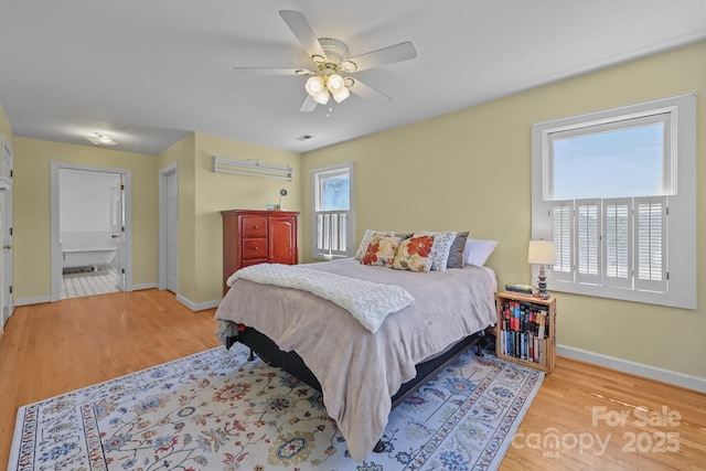 114 Windchime Ln, Mooresville, NC 28115 - bedroom with wood finished floors, a ceiling fan, and connected bathroom