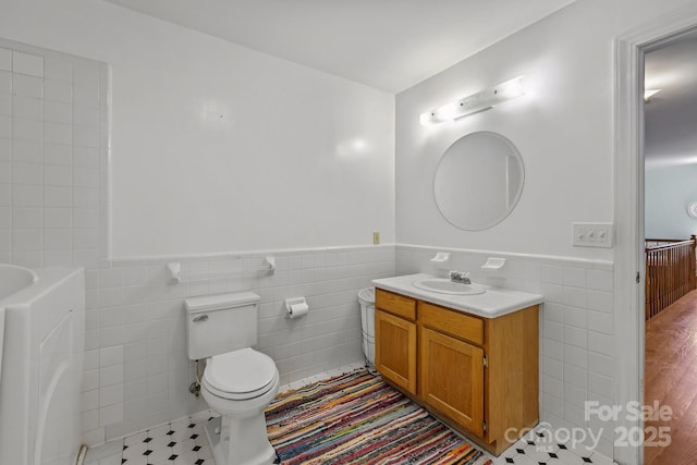114 Windchime Ln, Mooresville, NC 28115 - full bath featuring tile walls, vanity, a wainscoted wall, and a bathtub