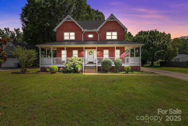 114 Windchime Ln, Mooresville, NC 28115 - view of front of house featuring covered porch, brick siding, and a yard