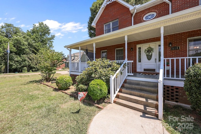 114 Windchime Ln, Mooresville, NC 28115 - property entrance featuring brick siding, a yard, and covered porch