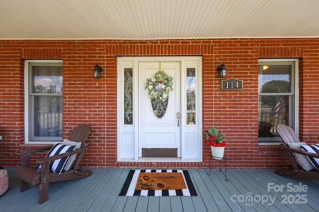 114 Windchime Ln, Mooresville, NC 28115 - doorway to property with brick siding and covered porch