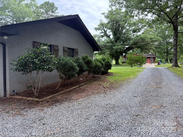 605 Impala Dr, Albemarle, NC 28001 - view of home's exterior with brick siding and gravel driveway