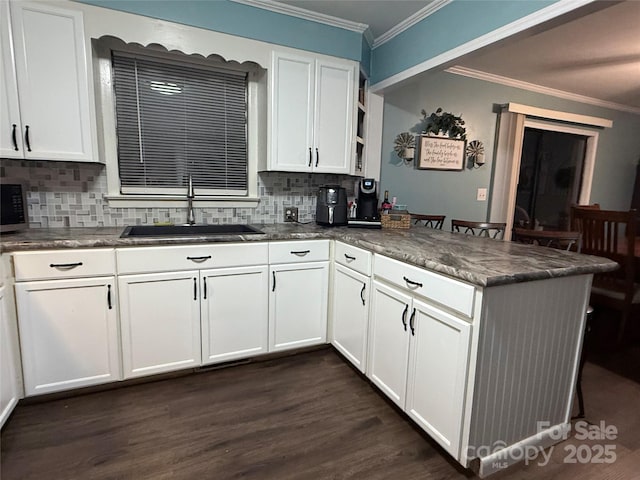 605 Impala Dr, Albemarle, NC 28001 - kitchen with a peninsula, crown molding, white cabinets, backsplash, and open shelves