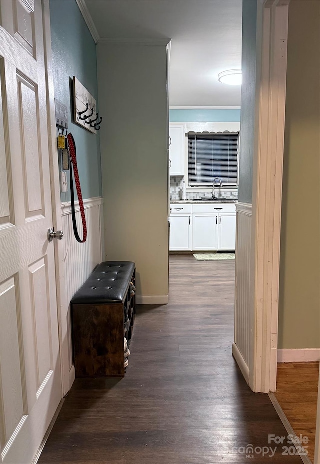605 Impala Dr, Albemarle, NC 28001 - hallway with dark wood-style floors, ornamental molding, and a wainscoted wall