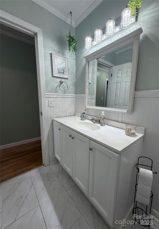 605 Impala Dr, Albemarle, NC 28001 - bathroom featuring marble look tile flooring, crown molding, vanity, and wainscoting