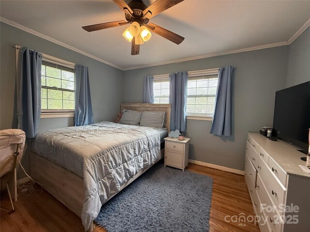 605 Impala Dr, Albemarle, NC 28001 - bedroom with wood finished floors, multiple windows, ornamental molding, and a ceiling fan